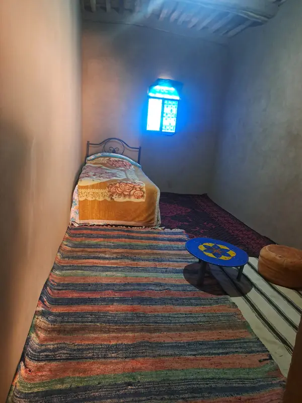 Mud-brick room with a blue window