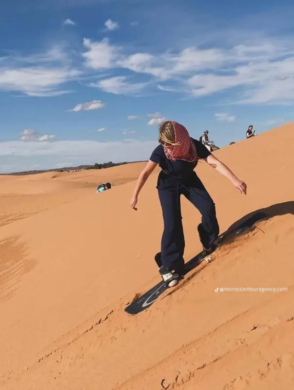 Sandboarding on an orange dune
